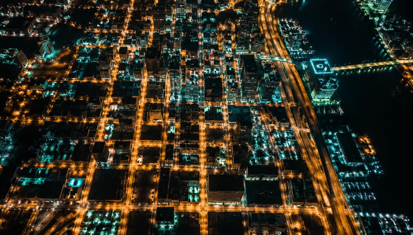 Aerial view of a city street grid glowing at night
